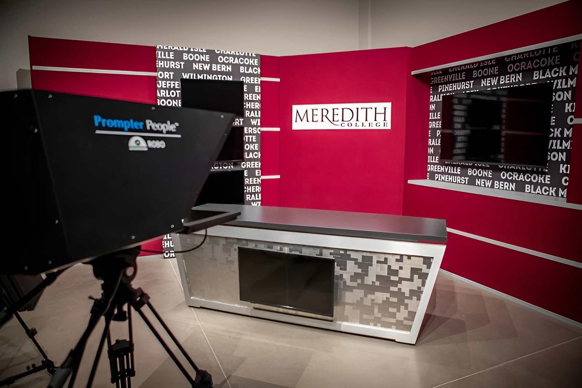 Broadcast studio set with news desk and teleprompter